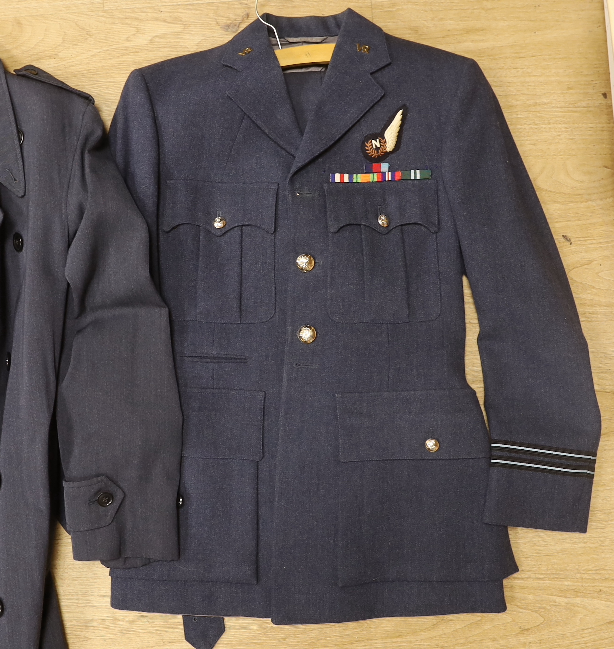 A collection of post-war RAF uniforms, comprising; two caps, double-breasted overcoat, dress uniform of jacket, trousers and gloves, two sets of jacket and trousers with ribbons for WWII awards, plus a pair of navigator’